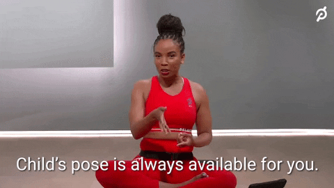 A woman sitting cross-legged says "Child's pose is always available for you" during a 10-minute workout
