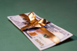 6-figure cash bonus tied in a gold bow.