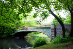 Connect with nature in NYC at Prospect Park Brooklyn, Historic Lullwater Bridge on a summer day.