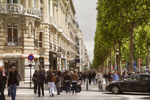Avenue des Champs-Elysees, camera locked down. In the context of a story about shopping for luxury goods while abroad