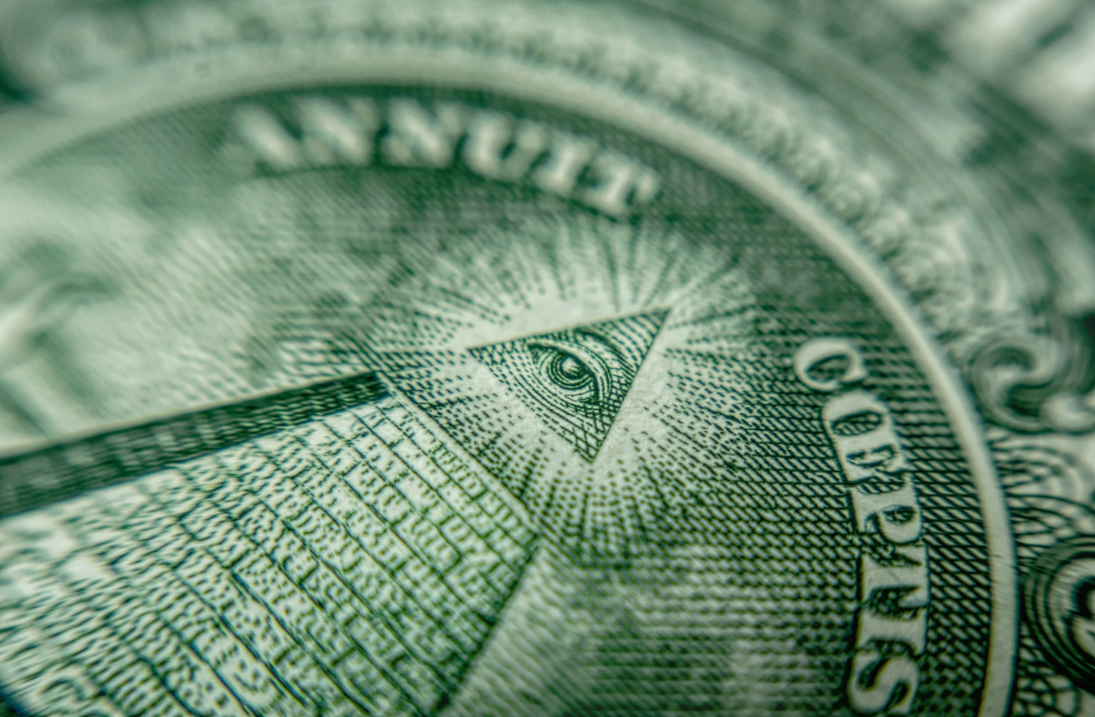 Close-up of eye and pyramid on the American dollar bill involved in the new global minimum tax plan