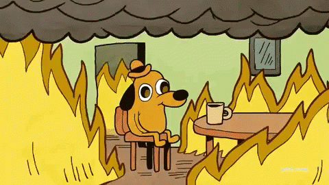 Animated dog sits at table as a room is set on fire with the caption, "This is fine."